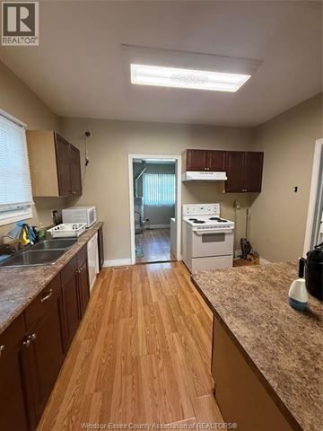 Windsor apartment for rent - A kitchen with wooden floors and a counter top.
