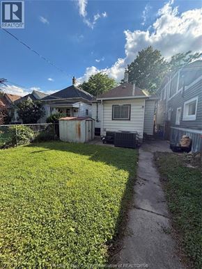 Windsor apartment for rent - A white house with a green lawn in front.