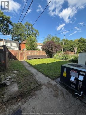 Windsor apartment for rent - A backyard with a fence and a utility box.