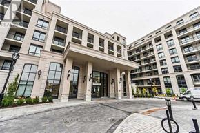 Markham (Unionville) condo for rent - A modern building with a large entrance and a parking area in front.