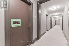 Markham (Unionville) condo for rent - A hallway with a door on the left and a sign on the door that says 703W.