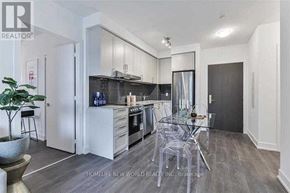 Markham (Unionville) condo for rent - A modern kitchen with a glass table and chairs.