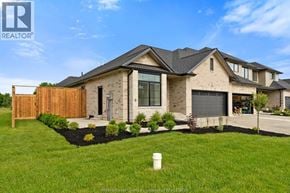 Amherstburg townhouse for rent - A modern house with a well-maintained lawn in front.