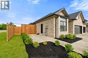 Amherstburg townhouse for rent - A modern house with a wooden fence and a well-maintained garden.