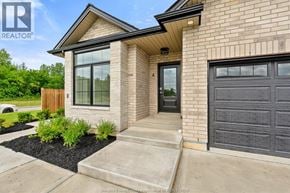 Amherstburg townhouse for rent - A house with a black garage door is for sale.