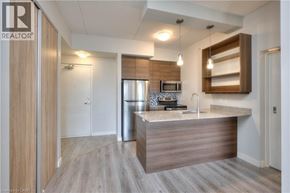 Waterloo condo for rent - A modern office space with a wooden reception desk and a fridge in the corner.