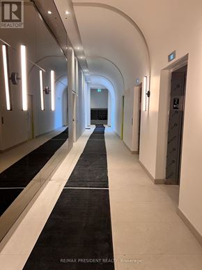 Burlington (Brant) condo for rent - A long hallway with a black and white striped carpet.
