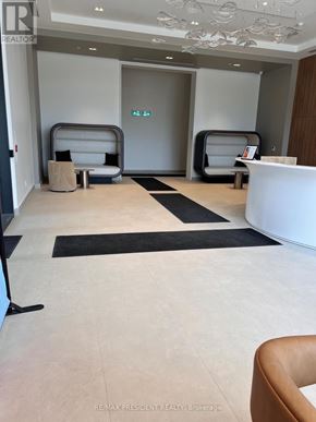 Burlington (Brant) condo for rent - A white reception desk with a black and white rug in front of it.