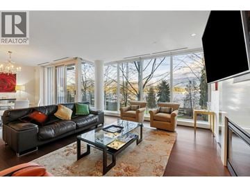 Vancouver townhouse for rent - A living room with a black couch and a glass coffee table.