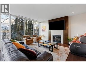 Vancouver townhouse for rent - A living room with a large leather couch and a fireplace.