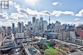 Toronto (Church-Yonge Corridor) condo for rent - A cityscape with a mix of modern and older buildings, a clear sky, and a prominent tower in the distance.