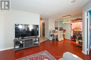 Toronto (Kennedy Park) condo for rent - A living room with a television and a rug on the floor.