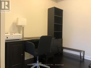 Mississauga (Creditview) condo for rent - A black chair sits in front of a desk with a printer on it.