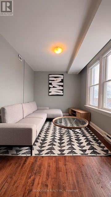 Oshawa (O'neill) apartment for rent - A living room with a white couch and a black and white rug.