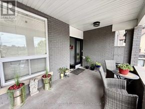 Niagara Falls (Downtown) multi-family for rent - A patio area with a table, chairs, and potted plants.