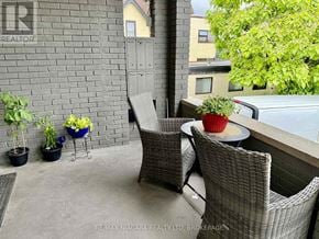 Niagara Falls (Downtown) multi-family for rent - A patio with a table, chairs, and plants.