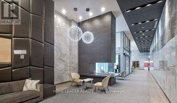 Toronto (Willowdale West) condo for rent - A modern living room with a grey sofa and a glass table.