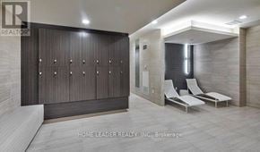 Toronto (Willowdale West) condo for rent - A brokerage office with a row of chairs and a wall of windows.