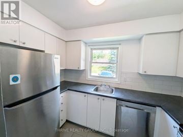 London East (East H) townhouse for rent - A kitchen with a stainless steel refrigerator and a window.