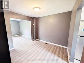 London East (East H) townhouse for rent - A room with a wooden floor and a white ceiling.