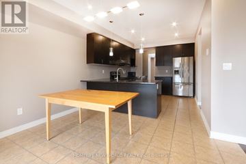 Richmond Hill (Jefferson) apartment for rent - A kitchen with a table and a TV mounted on the wall.