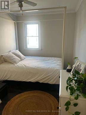 St. Catharines (Western Hill) apartment for rent - A bedroom with a bed, a ceiling fan, and a window.