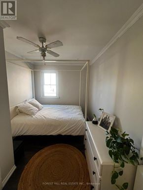 St. Catharines (Western Hill) apartment for rent - A bedroom with a bed, a ceiling fan, and a window.