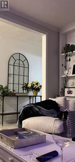 St. Catharines (Western Hill) apartment for rent - A living room with a couch, a table with a glass of wine and a book.