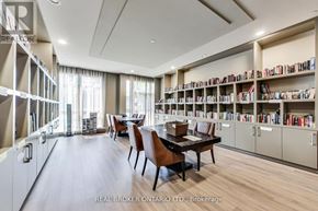 Toronto (Englemount-Lawrence) condo for rent - A room with a long table and chairs with a bookshelf on the side.