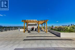Toronto (Englemount-Lawrence) condo for rent - A wooden pergola is situated on a rooftop terrace.