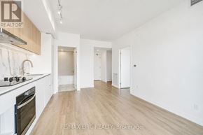 Toronto (York University Heights) condo for rent - A spacious kitchen with white cabinets and a wooden floor.