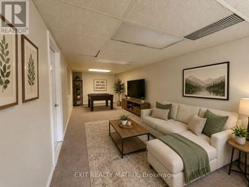 Ottawa townhouse for rent - A living room with a couch, coffee table, and a painting on the wall.