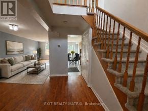 Ottawa townhouse for rent - A living room with a couch, a coffee table, and a staircase.