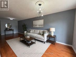 Ottawa townhouse for rent - A living room with a white couch, a coffee table, and a chandelier.