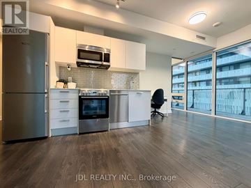 Toronto (Church-Yonge Corridor) condo for rent - A modern kitchen with stainless steel appliances and a black chair.