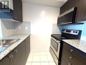 Toronto (Henry Farm) condo for rent - A kitchen with a black microwave above a black oven.