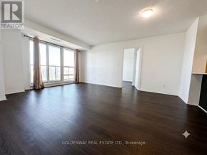 Toronto (Henry Farm) condo for rent - A spacious room with wooden flooring and a large window with curtains.