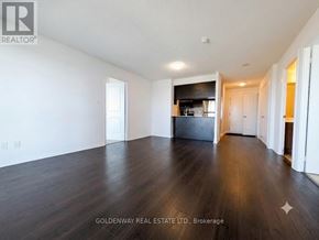 Toronto (Henry Farm) condo for rent - A spacious room with wooden floors and white walls, part of a house brokerage.