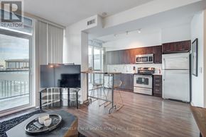 Toronto (Waterfront Communities) condo for rent - A modern kitchen with a refrigerator, oven, and microwave.