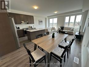 Barrie townhouse for rent - A well-lit kitchen and dining area with modern furniture.