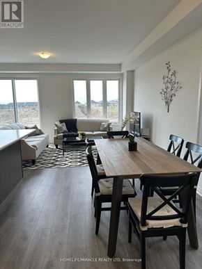 Barrie townhouse for rent - A dining room with a wooden table and chairs.