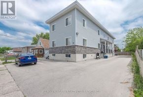 Welland (Lincoln/Crowland) fourplex for rent - A blue car is parked in front of a two-story house.