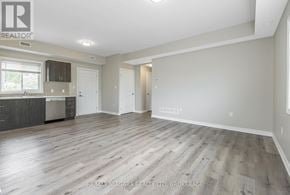Welland (Lincoln/Crowland) fourplex for rent - A spacious room with wooden flooring and white walls, ready for a new tenant.