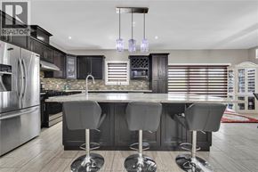 Lasalle apartment for rent - A modern kitchen with a center island and bar stools.