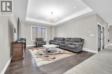Lasalle apartment for rent - A living room with a grey sofa and a wooden cabinet.