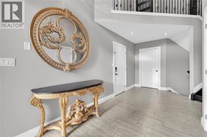 Lasalle apartment for rent - A golden framed mirror hangs on a wall above a black and gold console table.