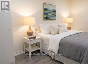 East Gwillimbury (Holland Landing) apartment for rent - A bedroom with a bed, nightstand, and lamp.