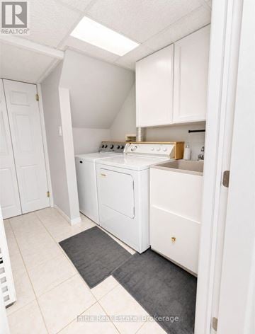 East Gwillimbury (Holland Landing) apartment for rent - A kitchen with white appliances and cabinets.