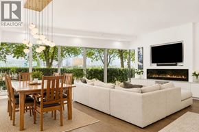 Vancouver apartment for rent - A modern living room with a fireplace and a dining table.