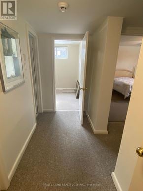Toronto (Bathurst Manor) duplex for rent - A hallway with a carpeted floor and white walls.